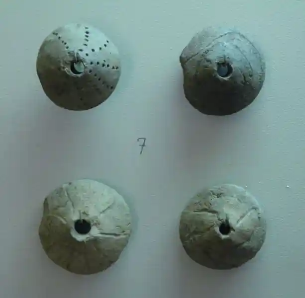 Nine-pointed cross on a clay with hole in the center